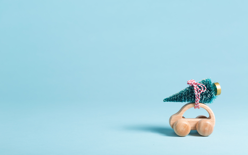 Wooden toy car with a Christmas tree attached to the roof